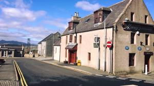 an old building on the side of a street at Morris Gardens Apartments in Oldmeldrum +5 photos