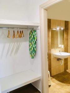 a bathroom with a sink and a toilet and a mirror at Sunset Apartments in Glinádhon