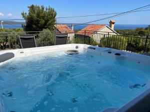 a large jacuzzi tub in a backyard at Podgora Experience Suite with jacuzzi in Nerezine