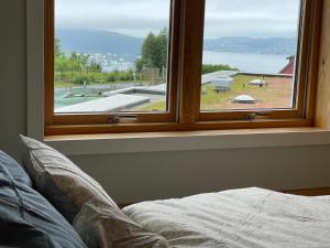 a window in a room with a bed and a view at Floien City House -free parking in Bergen