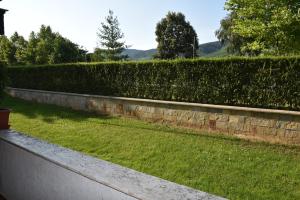 a stone retaining wall with a green lawn at Luxury apartment Pravets Golf and SPA - част от комплекса Hyatt in Pravets
