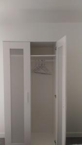 a closet with white walls and a white door at Maison en Location Fresnes sur Marne in Fresnes-sur-Marne