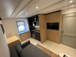 a living room with a couch and a flat screen tv at Podgora Experience Suite II in Nerezine