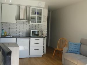 a small kitchen with a couch and a microwave at Appartement hyper centre Arcachon in Arcachon
