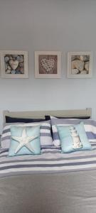 a bedroom with a bed with blue and white pillows at Seashells in Bridlington