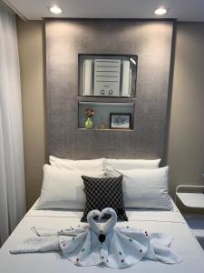 En eller flere senge i et værelse på Apart. Acolhedor na Praia de Itapuã