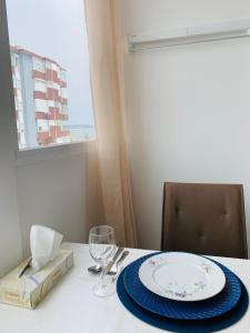 a table with a plate and a wine glass on it at The apartment near the beach in Oeiras in Paço de Arcos