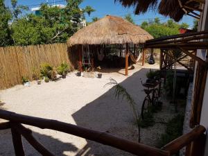 a patio area with a table, chairs, and umbrella at EncantaLuna in Holbox Island