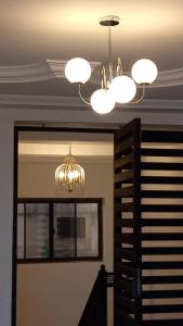 a chandelier hanging from a ceiling in a room at BAFFOUR APARTMENTS in Adiebaba