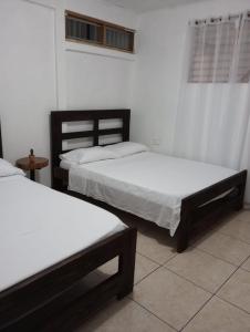 En eller flere senge i et værelse på LIMON´S HOUSE