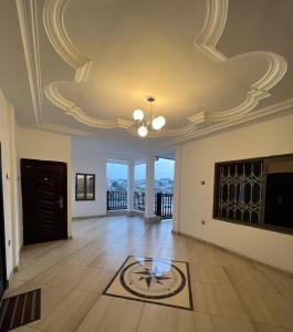 a living room with a coffered ceiling and a table at BAFFOUR APARTMENTS in Adiebaba