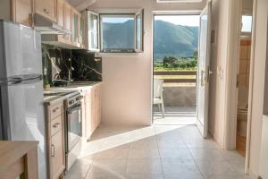 a kitchen with white appliances and a view of a mountain at Central Apartments in Alikanas