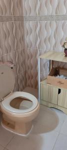 a bathroom with a white toilet in a room at La Casita de Mary in Santa Cruz de Barahona