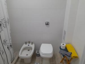 a small bathroom with a toilet and a sink at CASA CONFORTABLE II in Cordoba