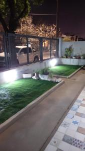 a backyard with a lawn with lights on it at CASA CONFORTABLE II in Cordoba