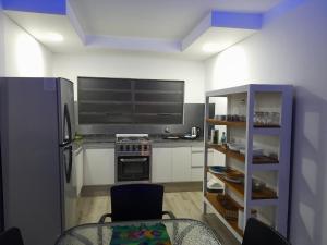a kitchen with a refrigerator and a table in it at CASA CONFORTABLE II in Córdoba