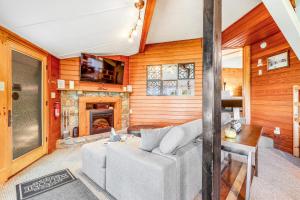 a living room with a couch and a fireplace at Slopesider 14B in Sugar Mountain
