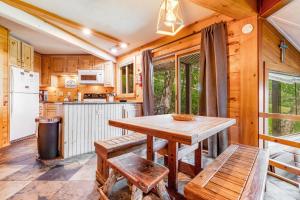 a kitchen with a wooden table and chairs in a cabin at Slopesider 14B in Sugar Mountain