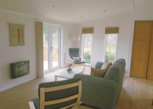 a living room with a couch and a chair at Llwyngwair Manor Holiday Park in Nevern