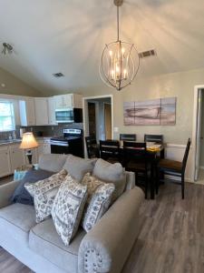 a living room with a couch and a dining room at Cottage on Shalin Circle in Woodville