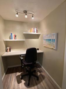 an office with a desk and a chair and shelves at Cottage on Shalin Circle in Woodville