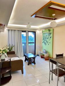 a living room with a couch and a table at One Oasis Condo 44sqm 1 Bedroom Beside SM Mall in Davao City