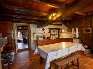 a kitchen with a large table in a room at Gîte familial avec WiFi près de Brantôme - FR-1-616-102 in Saint-Front-la-Rivière +8 photos