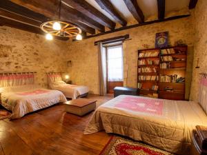 a bedroom with two beds and a book shelf at Gîte familial avec WiFi près de Brantôme - FR-1-616-102 in Saint-Front-la-Rivière