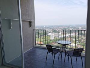 a balcony with a table and chairs and a view at Taiping Comfort Condo Homestay in Taiping