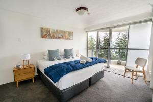 a bedroom with a large bed and a large window at Cashelmara Beachfront Apartments in Gold Coast +286 photos