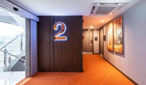 a hallway with a number sign on a wall at The One Smart Living in Bangkok