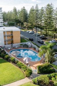 an aerial view of a resort with a pool and a parking lot at Cashelmara Beachfront Apartments in Gold Coast