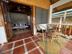 a room with a balcony with a bed and a table at Golden Monkey Beach Hotel in El Nido +37 photos