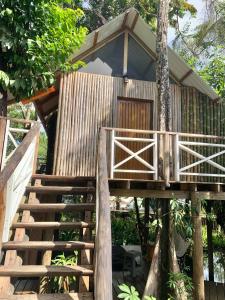 a tree house with stairs leading up to it at Boatique Hotel and Marina in Rio Dulce