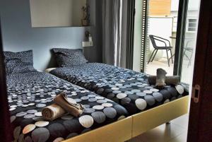 a bedroom with two beds and a chair at Apartaments Can Negret in Sitges