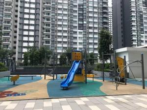 a playground with a slide in front of a building at Villa Selatan Southville City in Kampong Tangkas