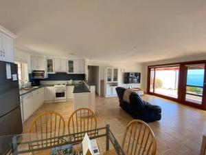 a kitchen and living room with a couch and a table at Kepals on the Coast - Kangaroo Island in Penneshaw