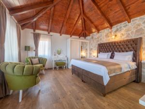 a bedroom with a bed and a desk and a chair at Harmonia Bungalows & Pool in Sveti Stefan