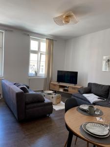 a living room with a couch and a table at Ferienwohnung Kamrath Altstadt von Neuruppin in Neuruppin