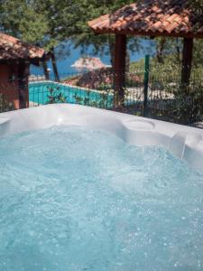 a jacuzzi tub with blue water in it at Harmonia Bungalows & Pool in Sveti Stefan