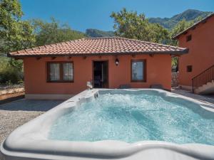 a hot tub in front of a house at Harmonia Bungalows & Pool in Sveti Stefan