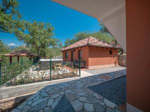 a house with a gate and a building at Harmonia Bungalows & Pool in Sveti Stefan