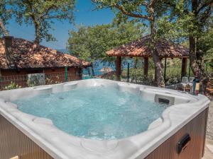 a hot tub in a backyard with a gazebo at Harmonia Bungalows & Pool in Sveti Stefan