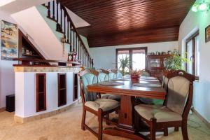 a dining room with a wooden table and chairs at OLE Apartment - Private Luxury Residence for an unforgettable experience in Timişoara