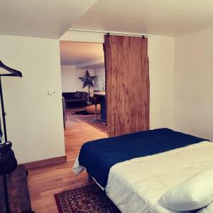 a bedroom with a bed and a desk in a room at Le monde d'Echozellia in Saint-Germain-des-Champs +43 photos