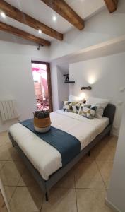 ein Schlafzimmer mit einem großen Bett in einem Zimmer in der Unterkunft LE BOISÉ GÉNILOIS- Campagne-Chic-Climatisé in Genilac