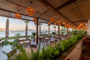 a restaurant with tables and chairs and a view of the ocean at Mirada Exclusive Bodrum in Bodrum City