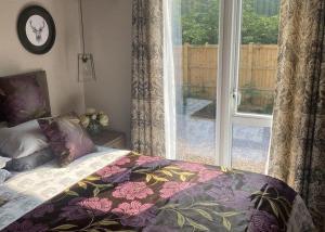 a bedroom with a bed and a window with a view at Ladera Retreat Lodges in Eaton