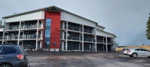 a large building with cars parked in a parking lot at Meritähti 205 in Kalajoki