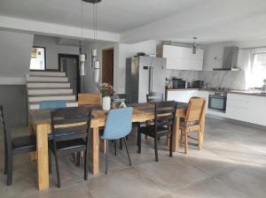 eine Küche und ein Esszimmer mit einem Holztisch und Stühlen in der Unterkunft Casa Nectaria in Moieciu de Jos